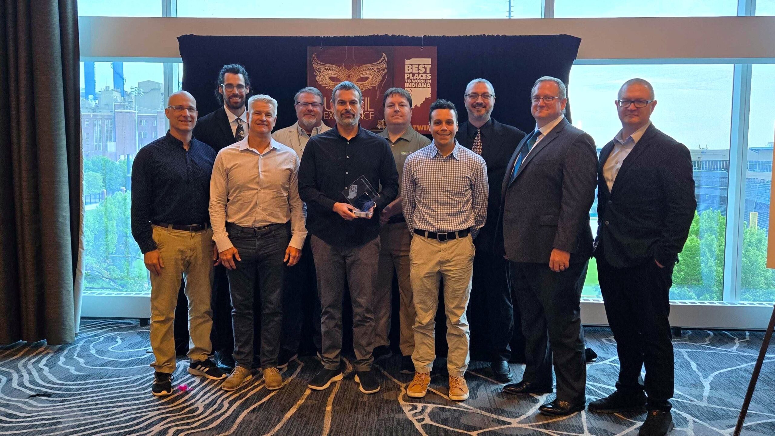 SEP 2025 Best Places to Work Award Winner representative group holding the trophy at the event