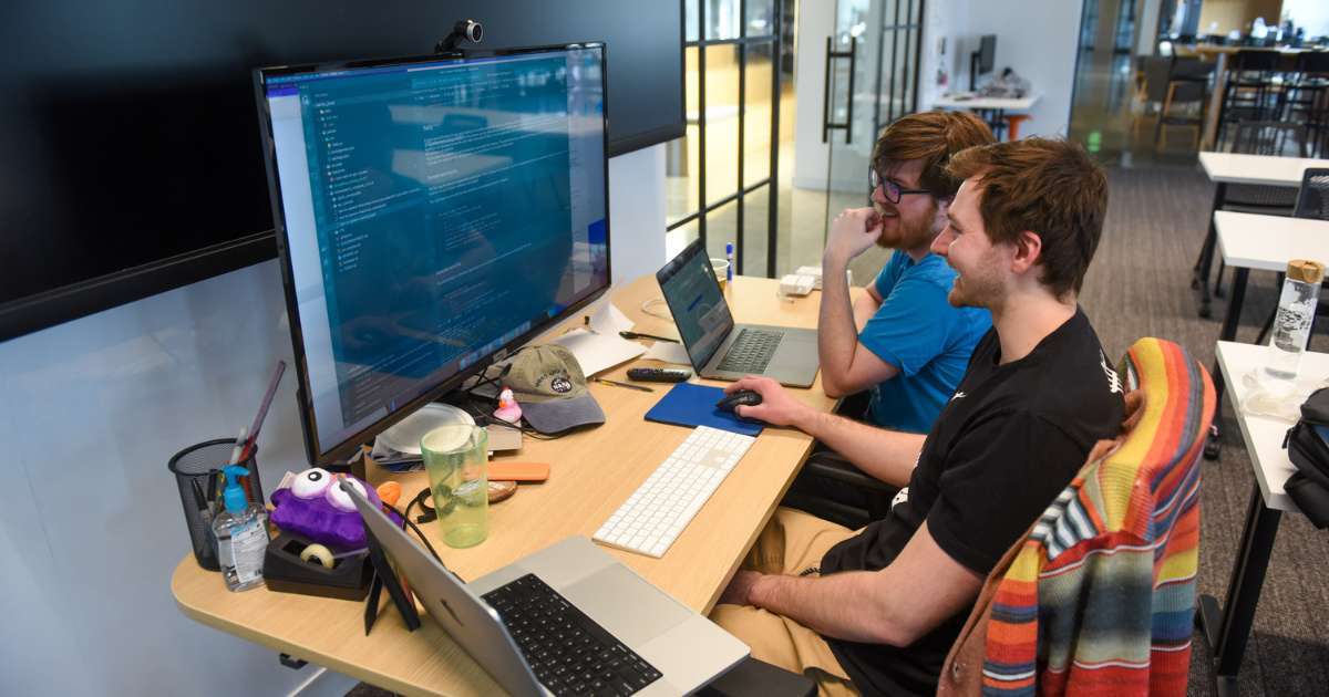 developers collaborating at a monitor