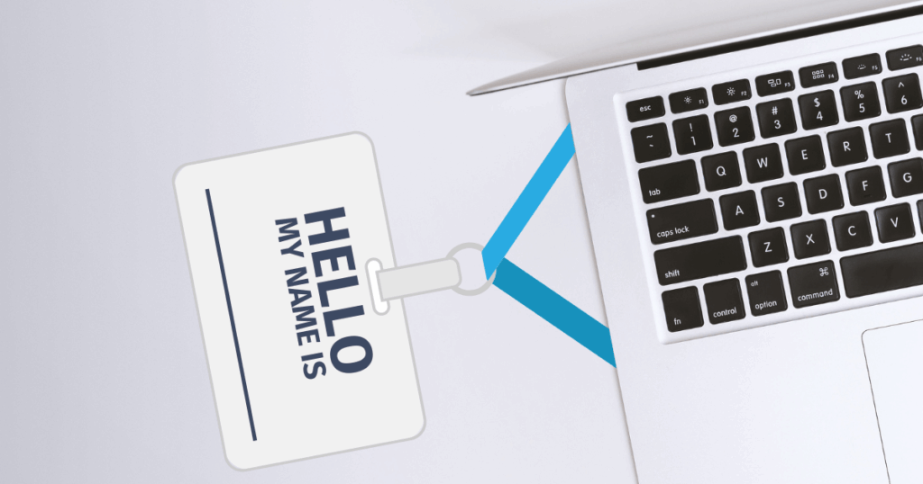 laptop with name tag attached that says "HELLO MY NAME IS" and a blank line