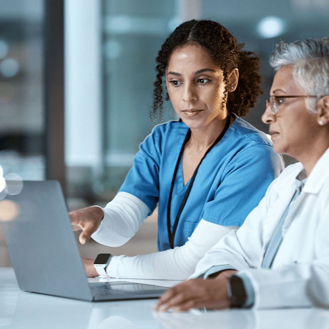 medical collaborators looking at a laptop screen