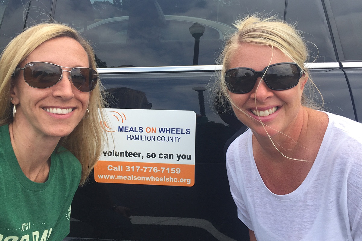 Tracie and Kelly delivering meals to the elderly with Meals on Wheels.