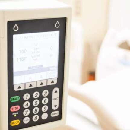 infusion pump in front of patient hospital bed